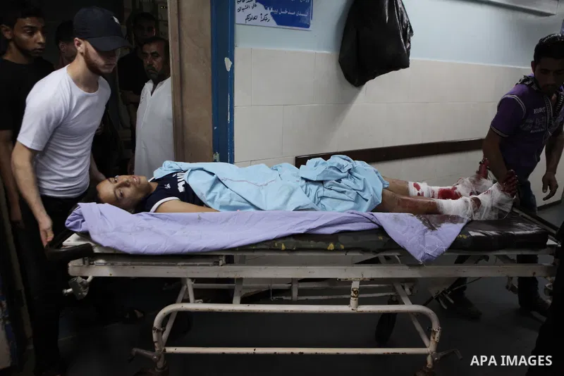 A Palestinian whom medics said was wounded in an Israeli air strike, lies on a bed at a hospital in Gaza City July 8, 2014. At least 14 people were killed in strikes on the Gaza Strip on Tuesday, Palestinian officials sa...