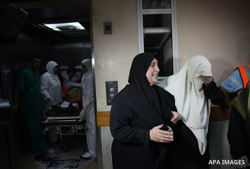 Palestinians mourn their relatives at the Shifa hospital after Israeli air strikes in Gaza City, on July 12, 2014. The world has implored Israel and Hamas to end hostilities as the toll from Israeli air strikes rose to 1...