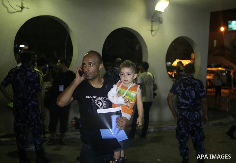 Palestinians and medics carry a boy, who medics said was wounded in Israeli shelling, at a hospital in Gaza City July 20, 2014. Israel said on Sunday it had expanded its ground offensive in Gaza and militants kept up roc...