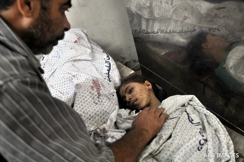 Palestinians inspect the bodies of their relatives at the morgue of the al-Shifa hospital in Gaza City, on July 20, 2014 July 20, 2014. The death toll in Gaza passed 400 as Israel pressed its biggest offensive in the enc...