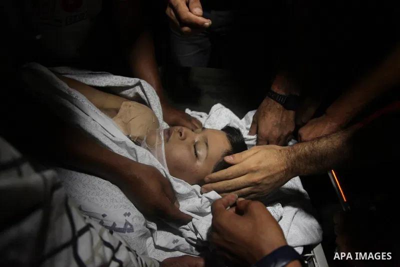 Relatives mourn the death of one Palestinian children from the Baker family, who was Injury by a shell fired by an Israeli naval gunboat, at the beach in Gaza Strip on July 16, 2014, Gaza City on July 22, 2014. Israel ke...
