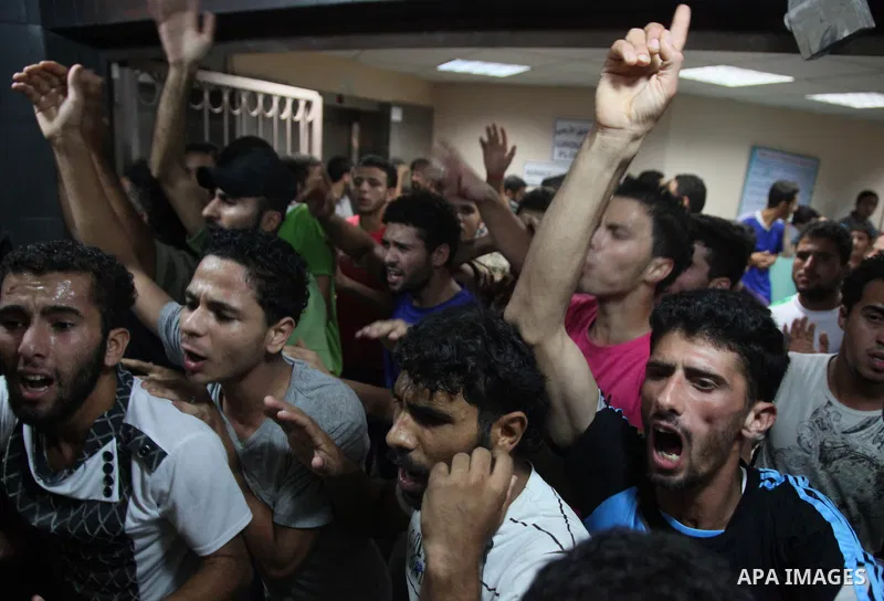 Relatives mourn the death of one Palestinian children from the Baker family, who was Injury by a shell fired by an Israeli naval gunboat, at the beach in Gaza Strip on July 16, 2014, Gaza City on July 22, 2014. Israel ke...