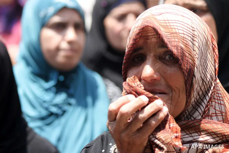 Palestinian relatives mourn during the funeral of Mahmoud al-Shawamreh in the West Bank town of Al-Ram near Jerusalem July 22, 2014. Israeli troops shot dead al-Shawamreh during clashes with stone-throwers in the occupie...