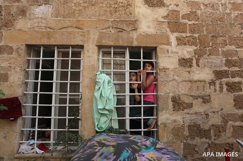 Displaced Palestinian women and children sit in a Greek Orthodox church where many Palestinians are taking shelter in Gaza City on July 23, 2014. For the first time in years, Gaza City's Greek Orthodox church is packed t...