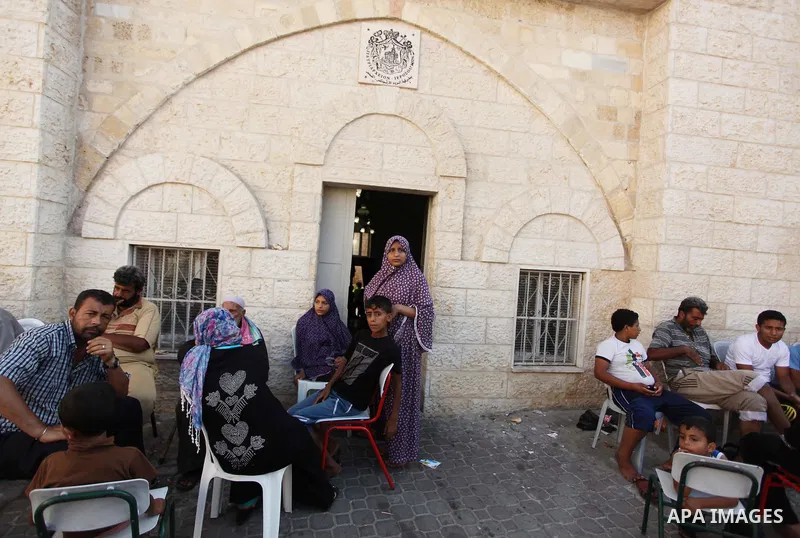Displaced Palestinian women and children sit in a Greek Orthodox church where many Palestinians are taking shelter in Gaza City on July 23, 2014. For the first time in years, Gaza City's Greek Orthodox church is packed t...