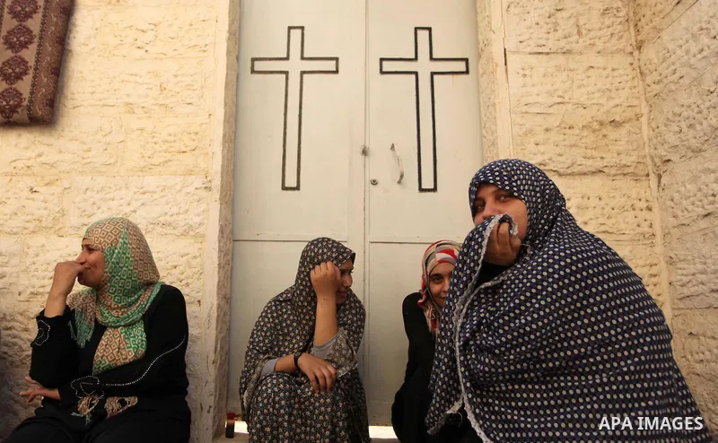 Displaced Palestinian women and children sit in a Greek Orthodox church where many Palestinians are taking shelter in Gaza City on July 23, 2014. For the first time in years, Gaza City's Greek Orthodox church is packed t...