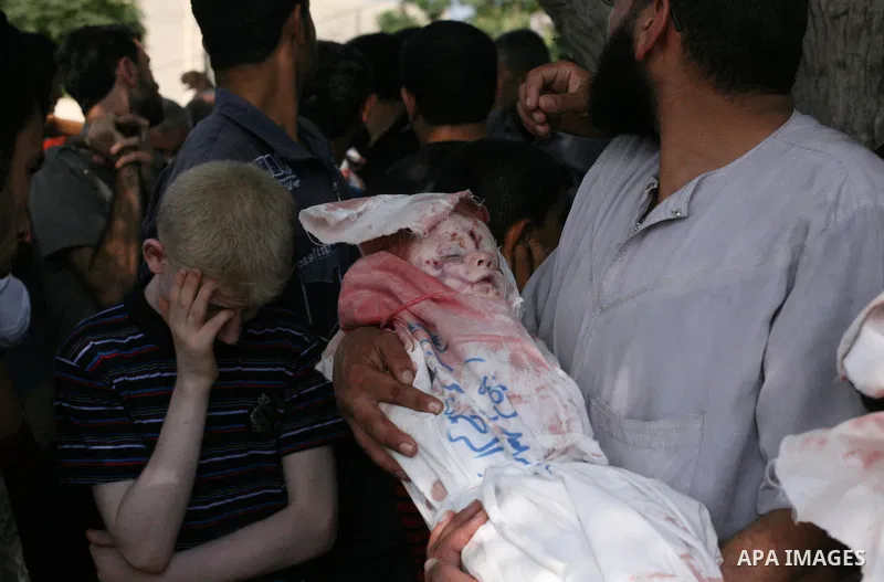 Palestinians bury the body of Palestinian boy Abdulrahamn Abed al-Nabi, 1, who medics said was killed in an Israeli air strike, during his funeral at a cemetery in the northern Gaza Strip July 24, 2014. Israel won a part...