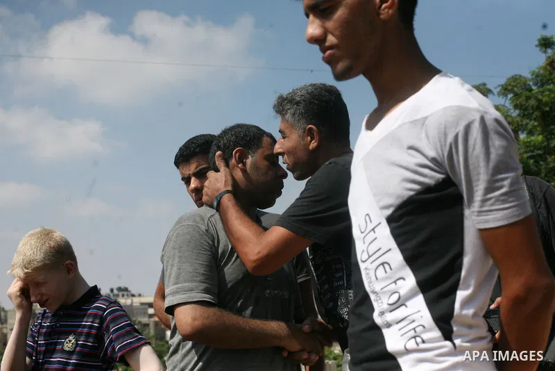 Palestinians bury the bodies of two Palestinian boys Abdulrahamn Abed al-Nabi, 1, and Hadi Abed al-Nabi, 3, who medics said were killed in an Israeli air strike, during their funeral at a cemetery in the northern Gaza St...