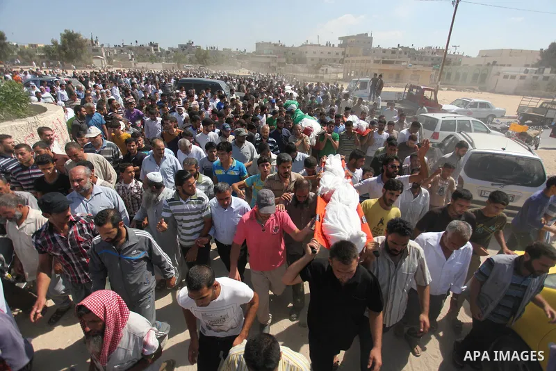 Palestinians carry the bodies of 11 member of al-Astal family, who were killed in an Israeli air strike, during their funeral in Khan Younis in the southern Gaza Strip, July 24, 2014. Hamas rejected a ceasefire the previ...