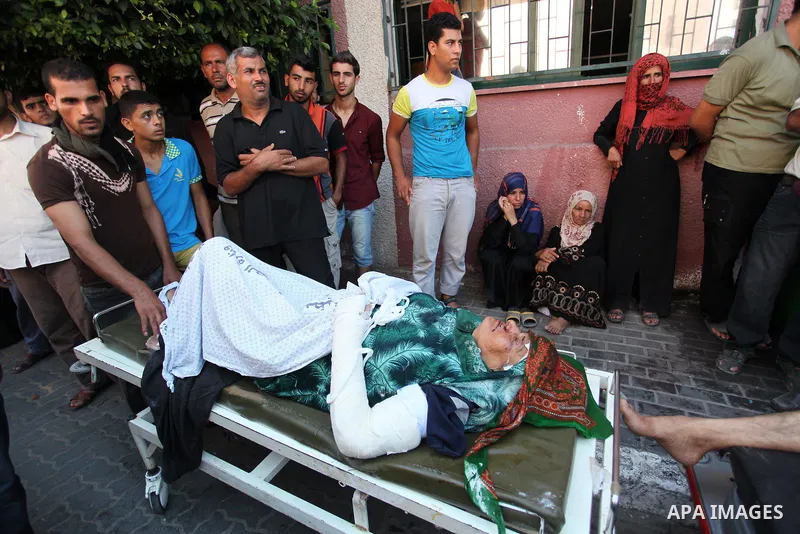 Palestinians wheel a woman, who medics said was wounded in an Israeli air strik, at a hospital in Khan Younis in the southern Gaza Strip, July 24, 2014. Hamas rejected a ceasefire the previous day to end 16 days of deadl...
