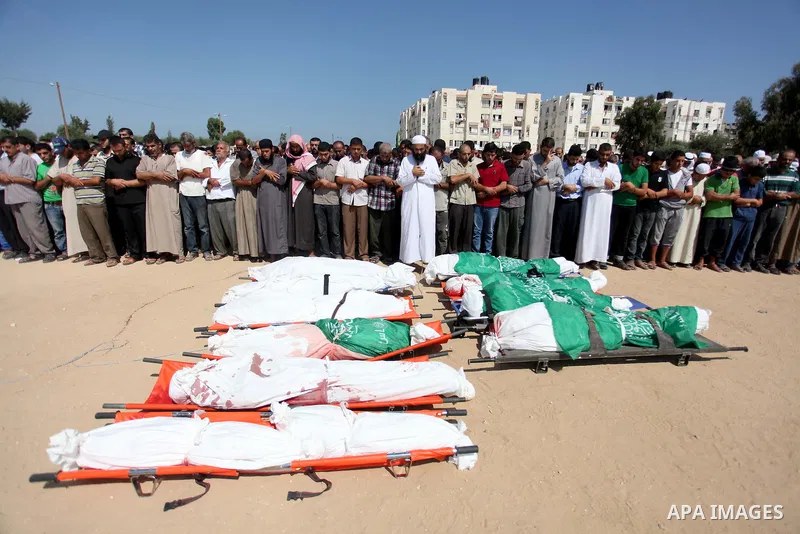 Palestinians pray over the bodies of 11 member of al-Astal family, who were killed in an Israeli air strike, during their funeral in Khan Younis in the southern Gaza Strip, July 24, 2014. Hamas rejected a ceasefire the p...