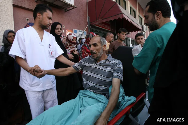 Palestinians wheel a stretcher transporting a man, who medics said was wounded by an Israeli air strike, at a hospital in Khan Younis in the southern Gaza Strip July 24, 2014. Israel won a partial reprieve from the econo...