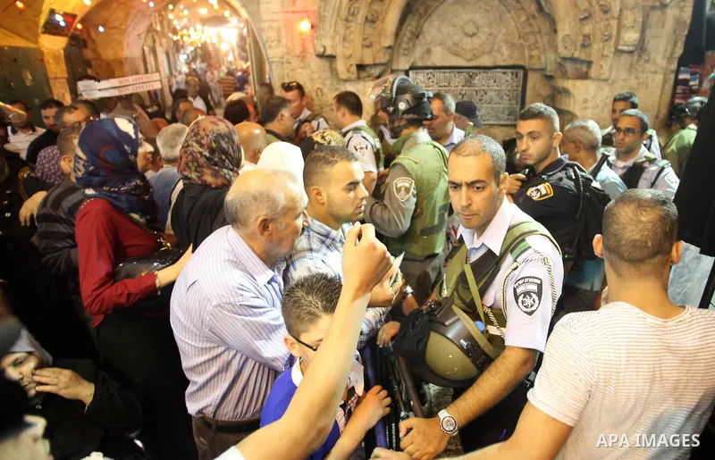 Israeli policemen stand guard as they barring entrance to the al-Aqsa mosque to men younger than 50 years, to mark Laylat al-Qadr, or Night of Destiny, in Jerusalem's Old City on July 24, 2014. On Friday, dozens of Pales...