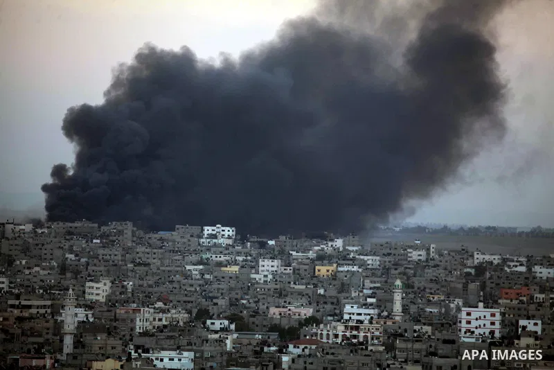 Smoke billows from a building hit by an Israeli air strike in Gaza City on July 25, 2014. Israel rejected a Gaza ceasefire proposal presented by US Secretary of State John Kerry, Israeli public television reported.. Phot...