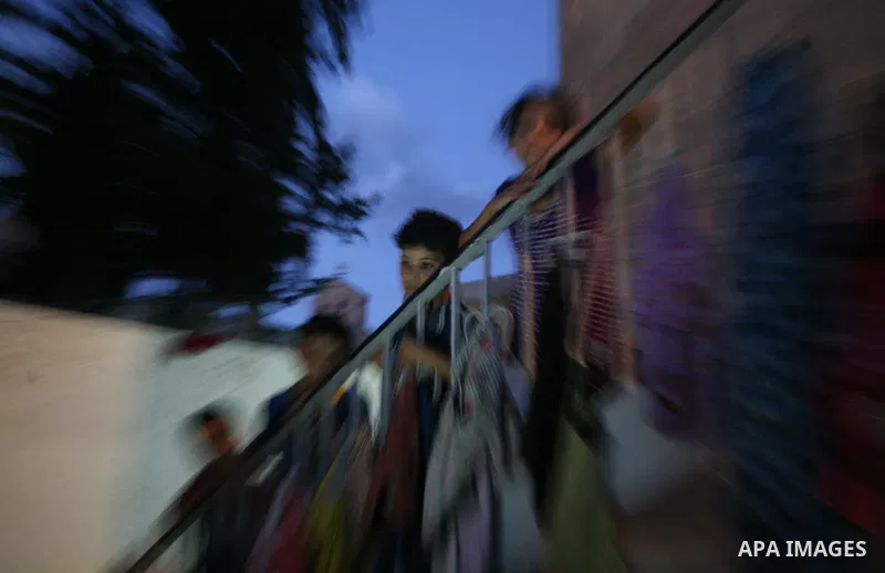 Displaced Palestinian children stand at the stairs of a Greek Orthodox church where many Palestinians are taking shelter in Gaza City on July 25, 2014. US Secretary of State John Kerry entered new meetings with UN chief...