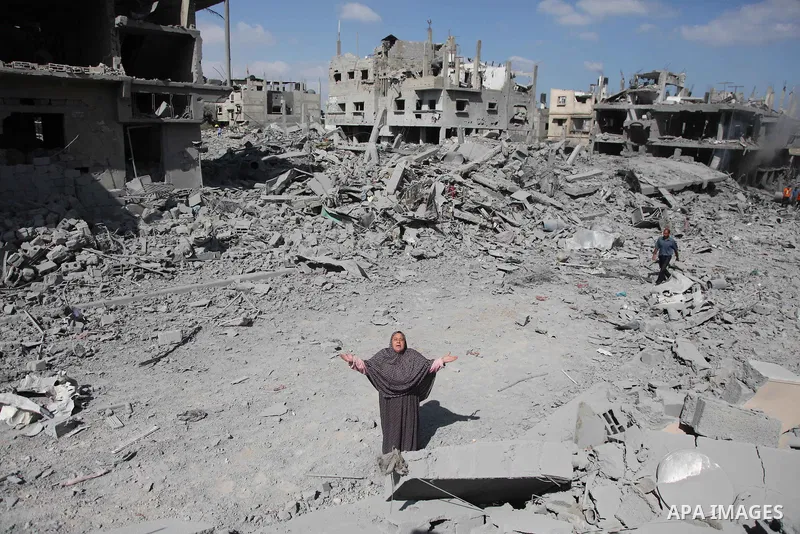 A Palestinian woman reacts at seeing destroyed homes in the northern district of Beit Hanun in the Gaza Strip during an humanitarian truce on July 26, 2014. Palestinians retrieved dozens of bodies from the rubble of Gaza...