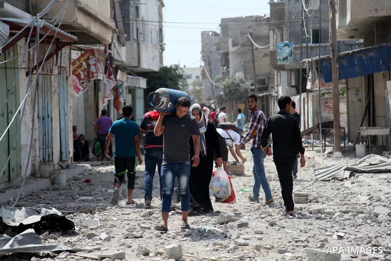 Palestinian return to check their homes and businesses in the northern district of Beit Hanun in the Gaza Strip during an humanitarian truce on July 26, 2014. The bodies of at least another 35 Palestinians were recovered...