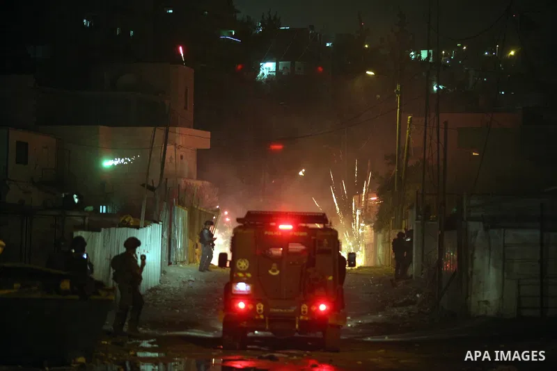 Israeli soldiers stand guard during clashes with Palestinian protesters during a protest against Israel's military operation in the Gaza Strip at the village of Issawiya in East Jerusalem on July 27, 2014. More than 1,00...