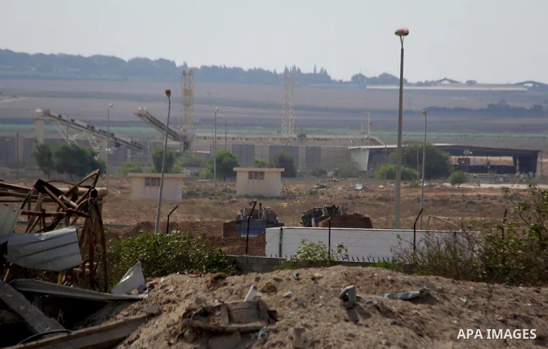 Israeli military tanks and bulldozers patrol amid of rubble of destroyed buildings at al-Shijaiyah district in the eastern Gaza City on July 26, 2014. Israeli troops remained in place across the Gaza Strip and continued...