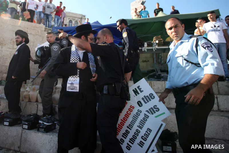 Israeli policemen disperse Neturei Karta Jews protesters during a protest against the Israeli offensive on the Gaza Strip, in front of Damascus gate in Jerusalem's Old City July 27, 2014. Palestinian medics said at least...