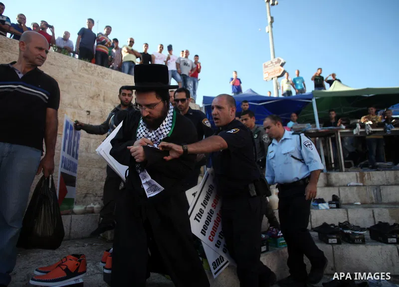 Israeli policemen disperse Neturei Karta Jews protesters during a protest against the Israeli offensive on the Gaza Strip, in front of Damascus gate in Jerusalem's Old City July 27, 2014. Palestinian medics said at least...