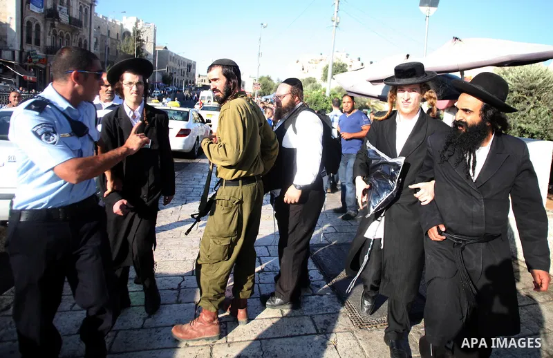 Israeli policemen disperse Neturei Karta Jews protesters during a protest against the Israeli offensive on the Gaza Strip, in front of Damascus gate in Jerusalem's Old City July 27, 2014. Palestinian medics said at least...