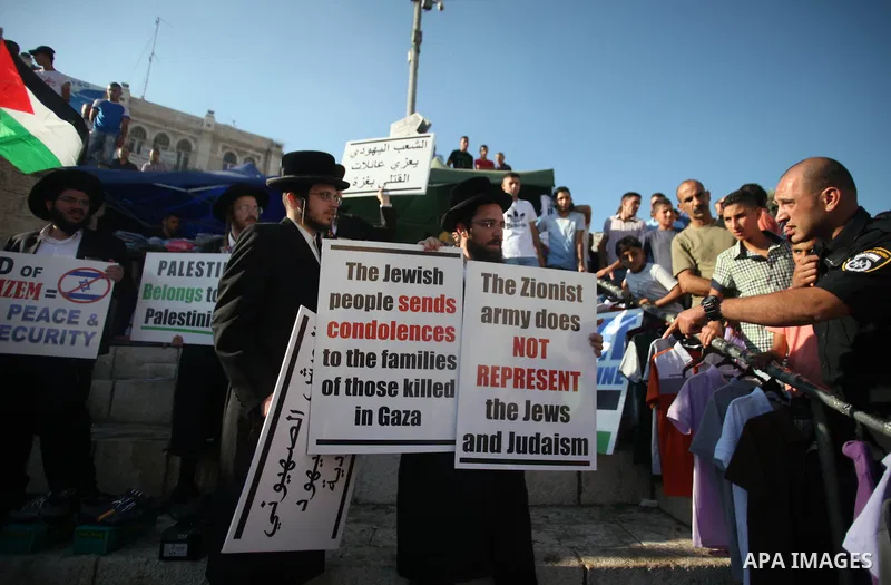 Israeli policemen disperse Neturei Karta Jews protesters during a protest against the Israeli offensive on the Gaza Strip, in front of Damascus gate in Jerusalem's Old City July 27, 2014. Palestinian medics said at least...
