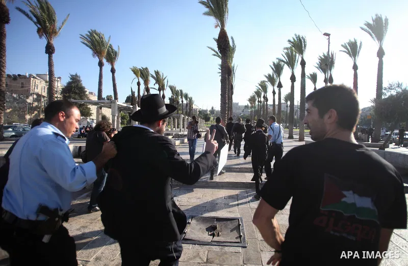 Israeli policemen detain a member of Neturei Karta Jews protester during a protest against the Israeli offensive on the Gaza Strip, in front of Damascus gate in Jerusalem's Old City July 27, 2014. Palestinian medics said...