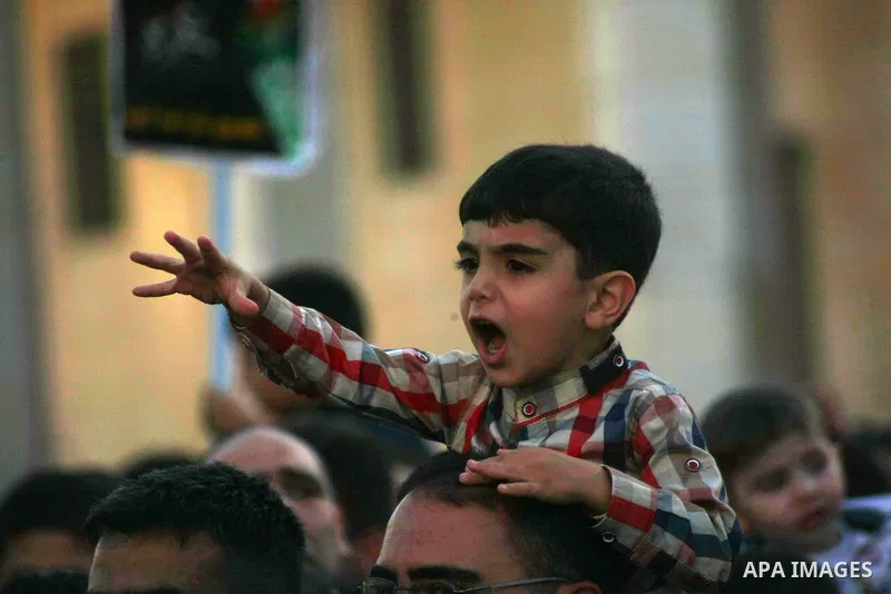 A Palestinian boy shout slogans during a a protest against the Israeli military operation in Gaza Strip as muslims celebrating the Eid al-Fitr festival, marking the end of the holy month of Ramadan, in the West Bank City...