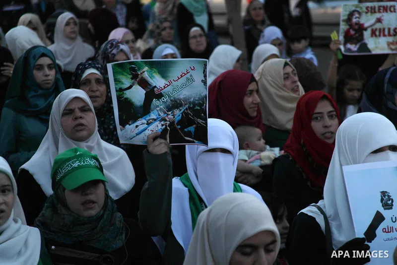 Female supporters of Hamas movement take part in a protest against the Israeli military operation in Gaza Strip as they celebrating the Eid al-Fitr festival, marking the end of the holy month of Ramadan, in the West Bank...