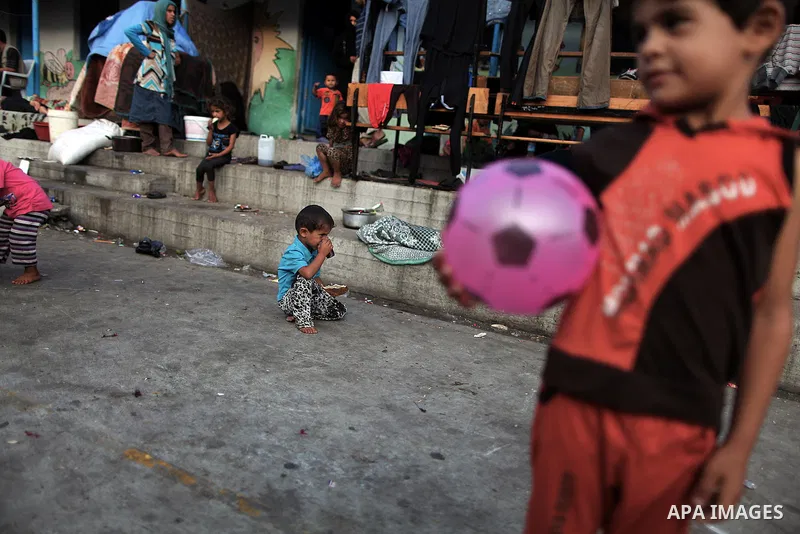 Displaced Palestinian children play as they celebrating the Eid al-Fitr festival at a United Nations school, in Gaza City on July 28, 2014. The U.N. Security Council agreed on a statement on Sunday urging Israel, Palesti...