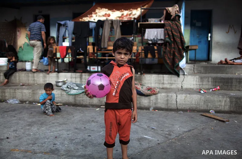 Displaced Palestinian children play as they celebrating the Eid al-Fitr festival at a United Nations school, in Gaza City on July 28, 2014. The U.N. Security Council agreed on a statement on Sunday urging Israel, Palesti...