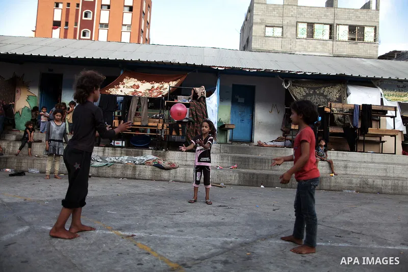 Displaced Palestinian children play as they celebrating the Eid al-Fitr festival at a United Nations school, in Gaza City on July 28, 2014. The U.N. Security Council agreed on a statement on Sunday urging Israel, Palesti...