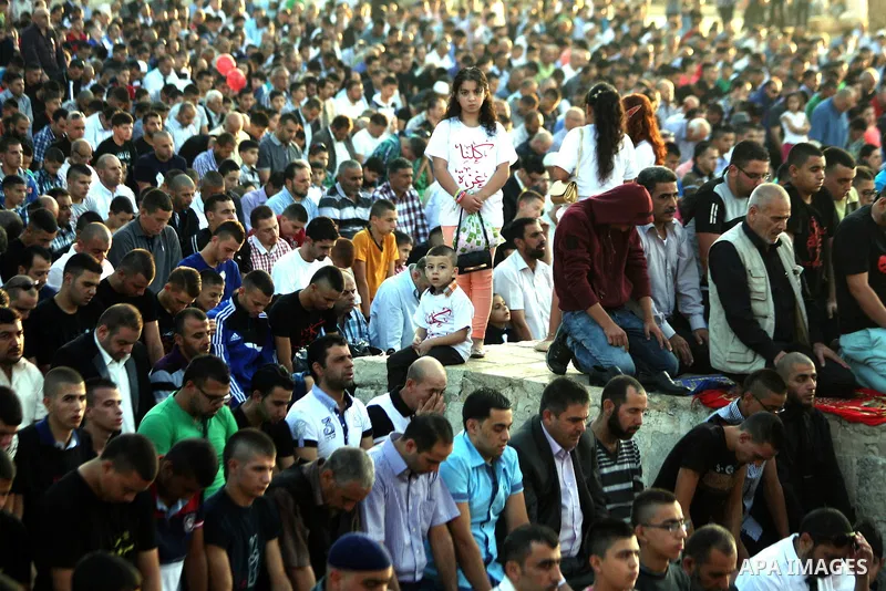 Palestinian Muslims attend the Eid al-Fitr prayer at al-Aqsa mosque in Jerusalem's Old City on July 28, 2014. Muslims around the world are celebrating Eid al-Fitr which marks the end of the month of Ramadan, after the si...