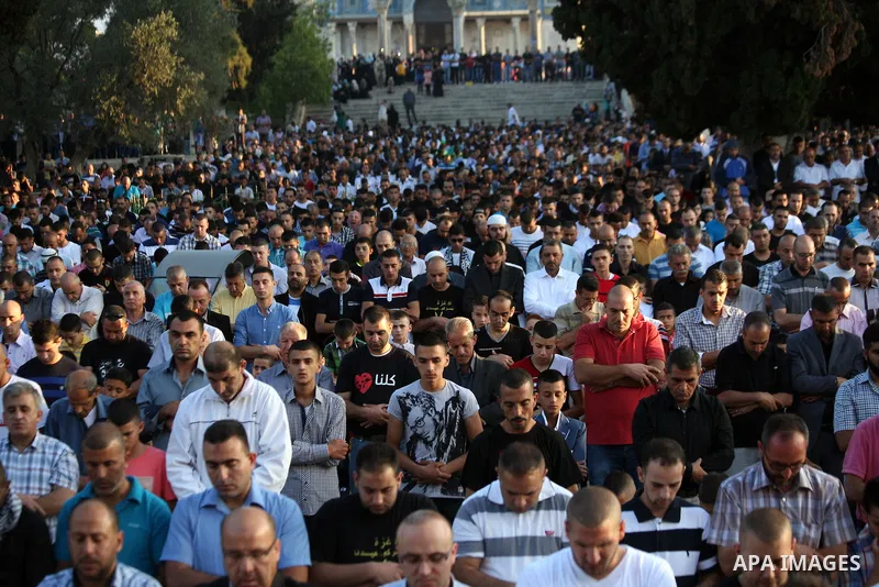 Palestinian Muslims attend the Eid al-Fitr prayer at al-Aqsa mosque in Jerusalem's Old City on July 28, 2014. Muslims around the world are celebrating Eid al-Fitr which marks the end of the month of Ramadan, after the si...