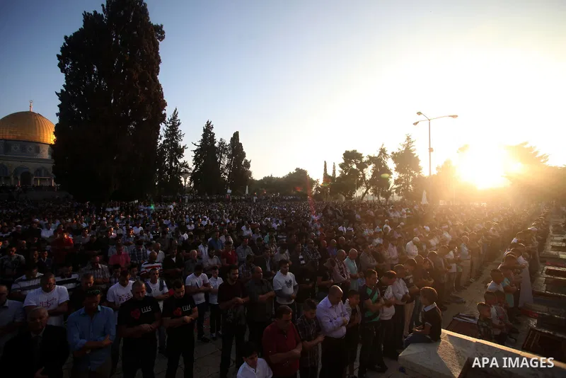 Palestinian Muslims attend the Eid al-Fitr prayer at al-Aqsa mosque in Jerusalem's Old City on July 28, 2014. Muslims around the world are celebrating Eid al-Fitr which marks the end of the month of Ramadan, after the si...
