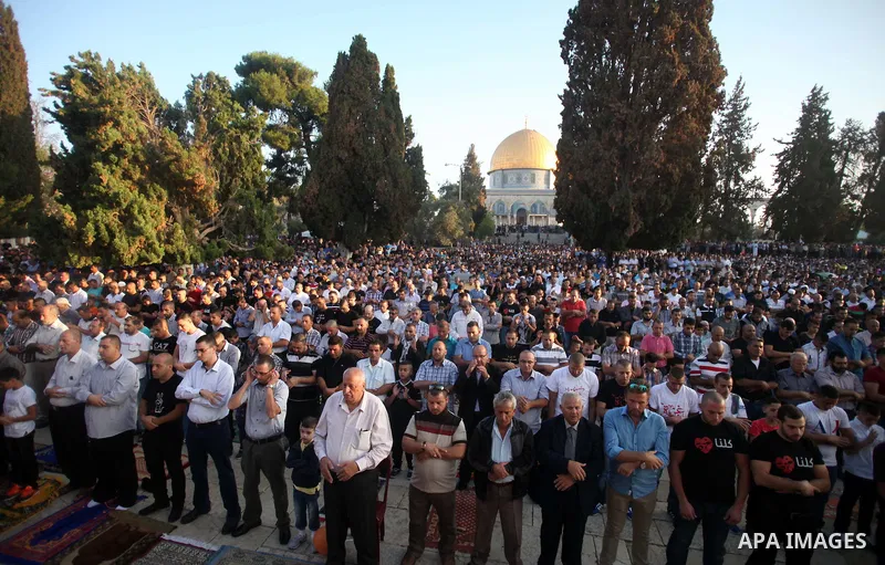 Palestinian Muslims attend the Eid al-Fitr prayer at al-Aqsa mosque in Jerusalem's Old City on July 28, 2014. Muslims around the world are celebrating Eid al-Fitr which marks the end of the month of Ramadan, after the si...