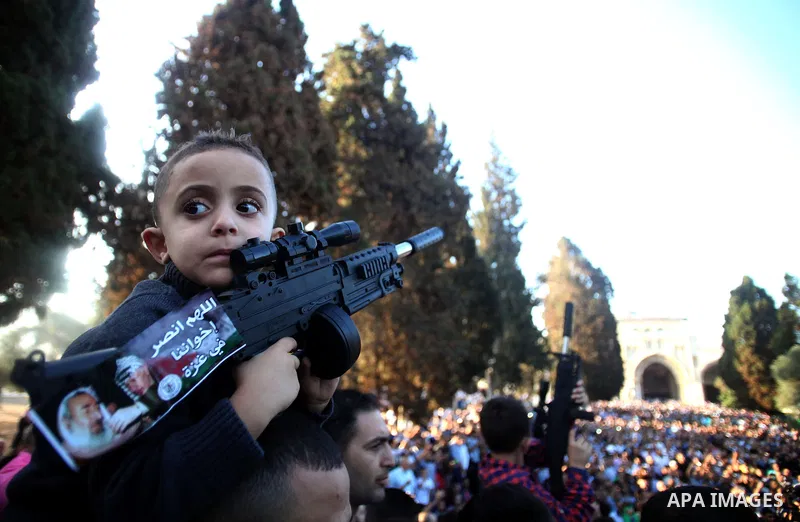 A Palestinian boy holds a gun toy during a protest against the Israeli military operation on Gaza Strip following the Eid al-Fitr prayer at al-Aqsa mosque in Jerusalem's Old City on July 28, 2014. Muslims around the worl...