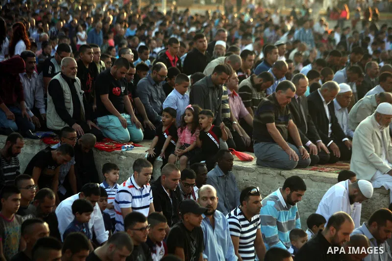 Palestinian Muslims attend the Eid al-Fitr prayer at al-Aqsa mosque in Jerusalem's Old City on July 28, 2014. Muslims around the world are celebrating Eid al-Fitr which marks the end of the month of Ramadan, after the si...