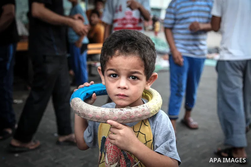 Displaced Palestinians gather at an United Nations (UN) school in Jabalia in the northern Gaza Strip, where they found refugee with their families after fleeing their homes in areas under heavy Israeli bombardment in the...