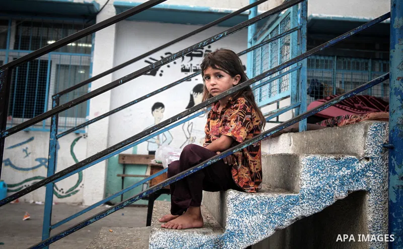 Displaced Palestinian girl sit at an United Nations (UN) school in Jabalia in the northern Gaza Strip, where they found refugee with their families after fleeing their homes in areas under heavy Israeli bombardment in th...