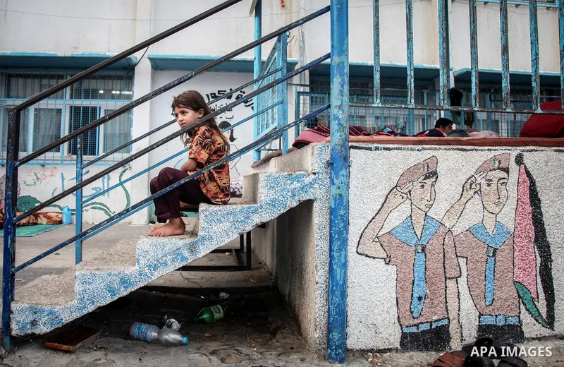 Displaced Palestinian girl sit at an United Nations (UN) school in Jabalia in the northern Gaza Strip, where they found refugee with their families after fleeing their homes in areas under heavy Israeli bombardment in th...