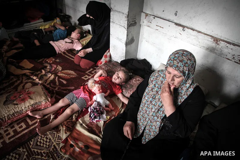 Displaced Palestinian girls play inside a room at an United Nations (UN) school in Jabalia in the northern Gaza Strip, where they found refugee with their families after fleeing their homes in areas under heavy Israeli b...