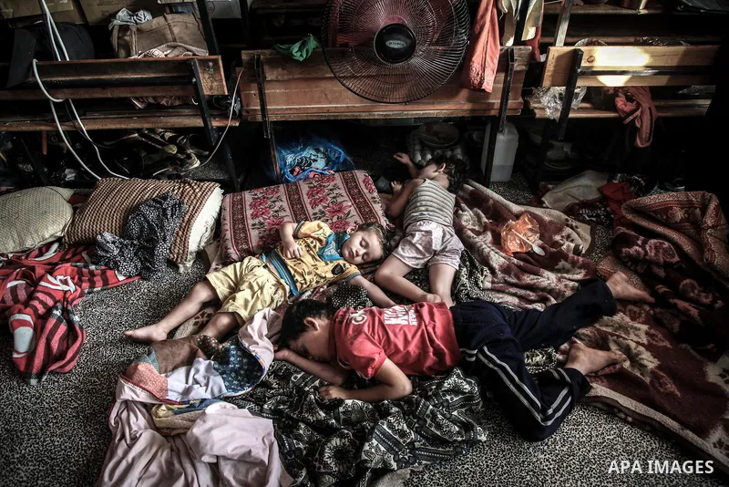 Displaced Palestinian girls play inside a room at an United Nations (UN) school in Jabalia in the northern Gaza Strip, where they found refugee with their families after fleeing their homes in areas under heavy Israeli b...