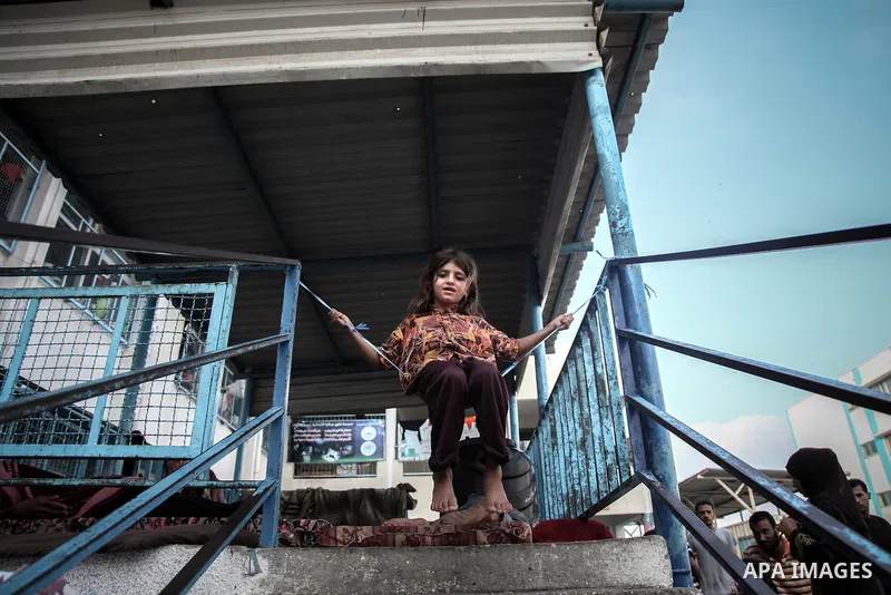 Displaced Palestinian girl play at an United Nations (UN) school in Jabalia in the northern Gaza Strip, where they found refugee with their families after fleeing their homes in areas under heavy Israeli bombardment in t...