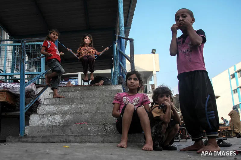 Displaced Palestinians gather at an United Nations (UN) school in Jabalia in the northern Gaza Strip, where they found refugee with their families after fleeing their homes in areas under heavy Israeli bombardment in the...