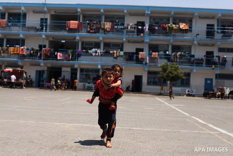 Displaced Palestinian children play at an United Nations (UN) school in Jabalia in the northern Gaza Strip, where they found refugee with their family after fleeing their home in an area under heavy Israeli bombardment i...