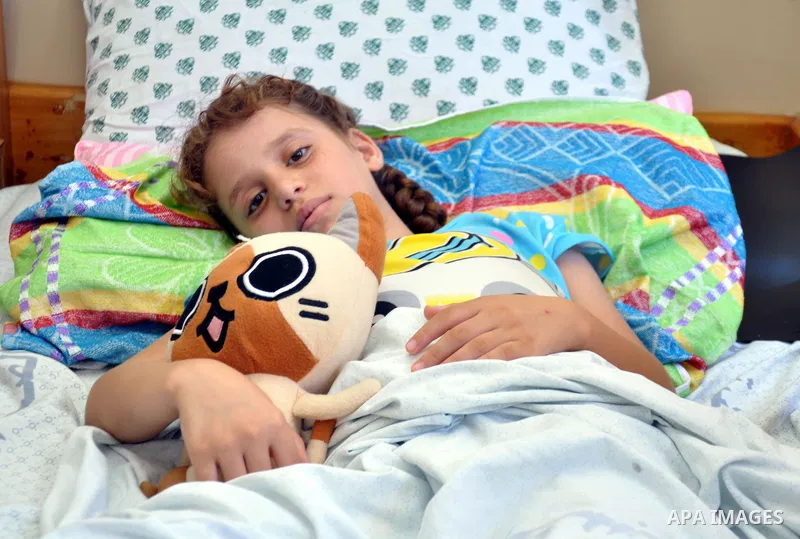 Palestinian Children rests at the Shifa hospital to receiving treatment on the first day of the Muslim festival of Eid al-Fitr in Gaza City on July 28, 2014. on the beginning of the Muslim Eid festival ending the month-l...