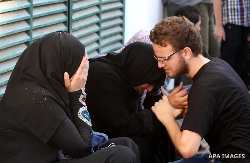 Palestinian mourners cry at Gaza City's al-Shifa hospital after an explosion killed at least seven children in a public playground in the beachfront Shati refugee camp on July 28, 2014. At least 10 Palestinians are kille...