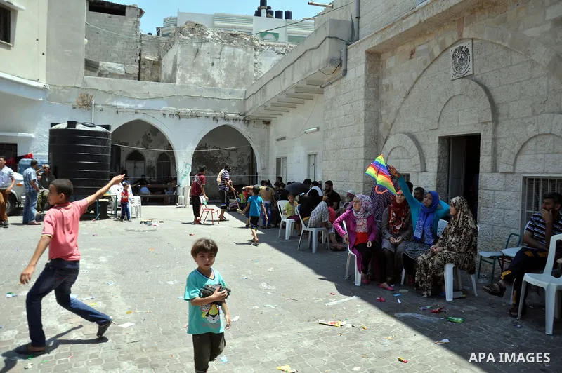 Displaced Palestinian children play as they are celebrating the Eid al-Fitr festival at the Saint Porphyrios church, in Gaza city on July 28, 2014. Security Council agreed on a statement urging Israel, Palestinians and I...